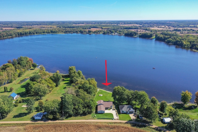 birds eye view of property with a water view and a wooded view