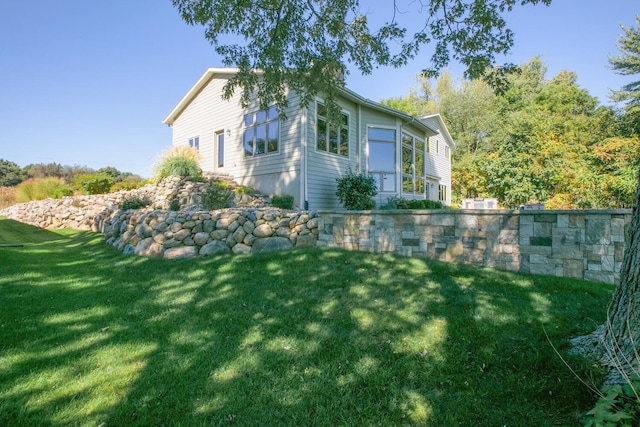 view of home's exterior with a lawn