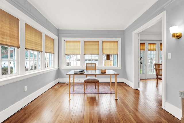 office with ornamental molding, wood finished floors, and a wealth of natural light