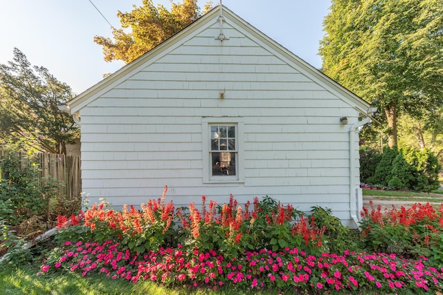 view of home's exterior with fence