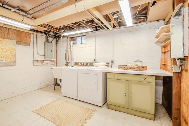 clothes washing area featuring cabinet space, electric panel, a sink, and independent washer and dryer