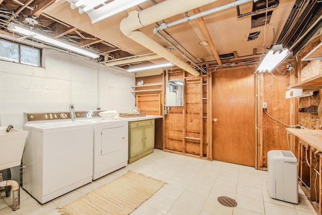 washroom featuring laundry area, washer and clothes dryer, and light floors