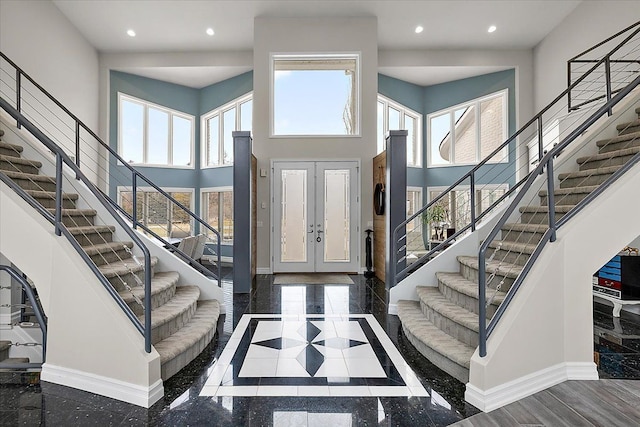 foyer with a high ceiling, recessed lighting, and baseboards