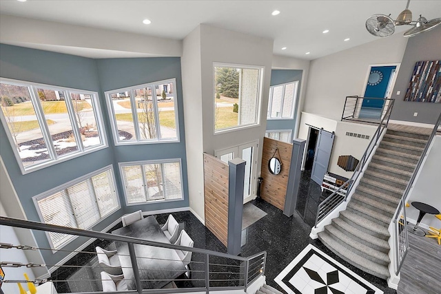 living area with recessed lighting, high vaulted ceiling, stairs, and baseboards