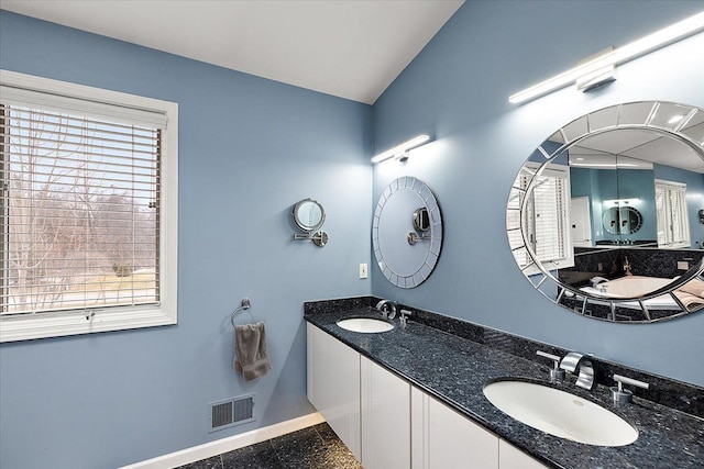 bathroom featuring visible vents, plenty of natural light, baseboards, and a sink