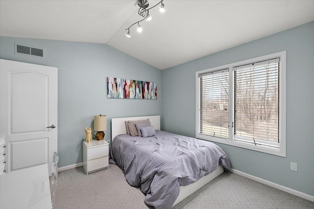 bedroom featuring visible vents, light carpet, baseboards, rail lighting, and lofted ceiling