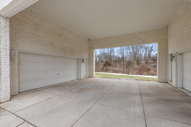 garage featuring concrete driveway