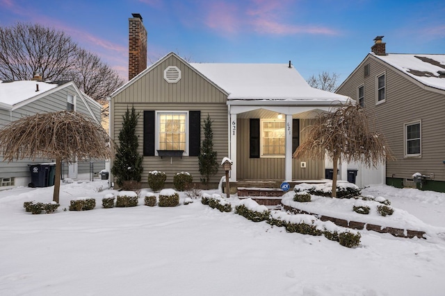 view of front of house with a chimney and board and batten siding