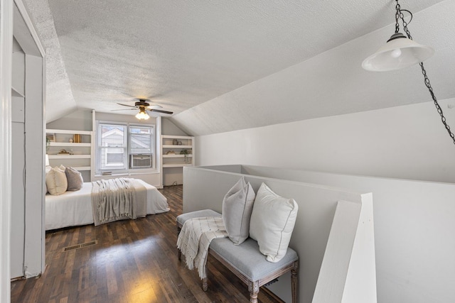 bedroom featuring a textured ceiling, dark wood-style flooring, visible vents, a ceiling fan, and vaulted ceiling