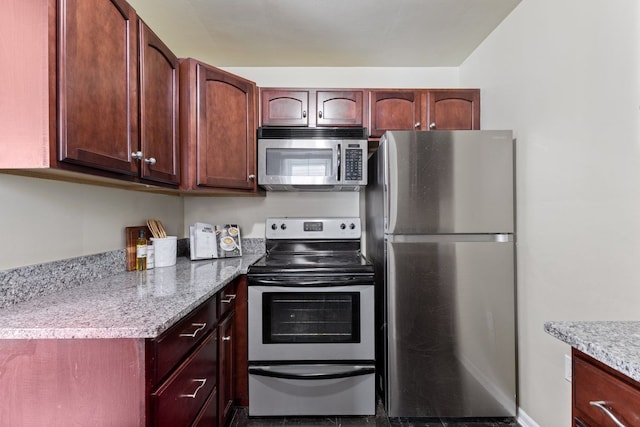 kitchen with stainless steel appliances and light stone counters