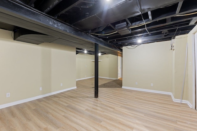 finished basement with light wood finished floors and baseboards