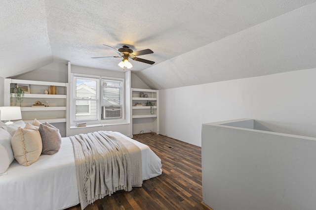 bedroom featuring lofted ceiling, dark wood-type flooring, a ceiling fan, a textured ceiling, and cooling unit