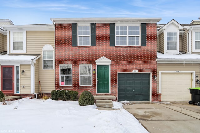 multi unit property featuring driveway, entry steps, a garage, and brick siding