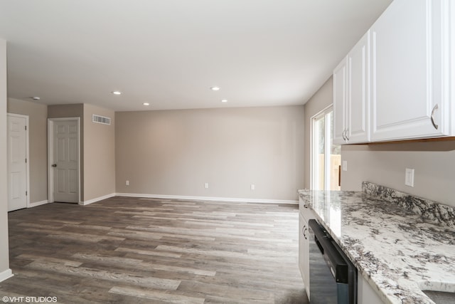 kitchen with visible vents, light stone countertops, white cabinetry, and dishwasher