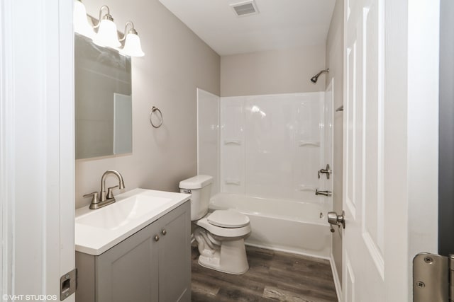 bathroom featuring toilet, shower / bath combination, wood finished floors, vanity, and visible vents