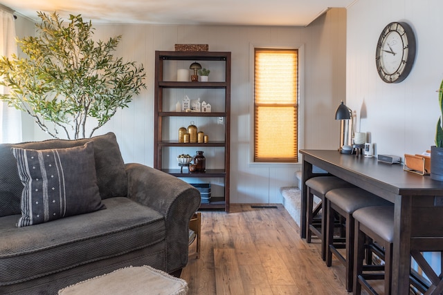 living area featuring wood-type flooring and visible vents