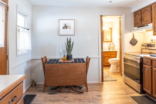 dining space with visible vents, light wood-style flooring, and baseboards