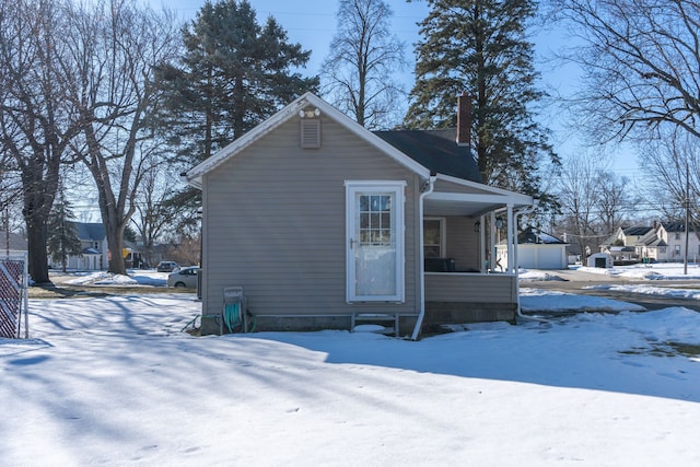 exterior space featuring a chimney and a porch