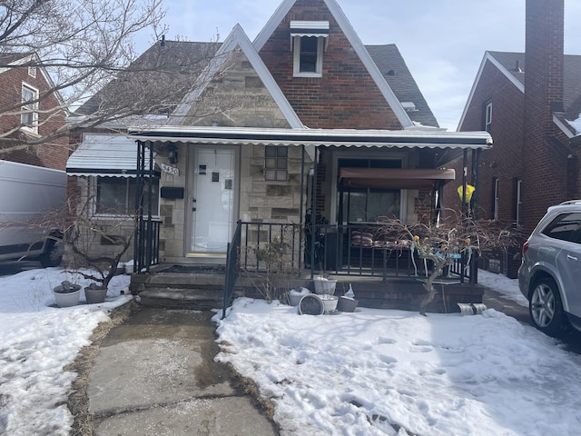 view of front facade with stone siding and covered porch