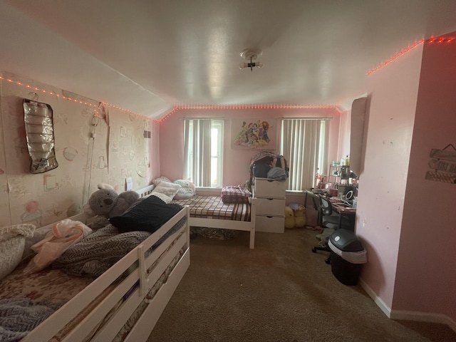 bedroom with vaulted ceiling and dark colored carpet