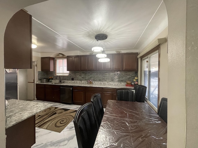 kitchen featuring a sink, dark brown cabinetry, tasteful backsplash, and dishwasher