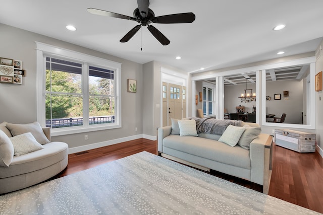 living area featuring baseboards, visible vents, dark wood finished floors, and recessed lighting