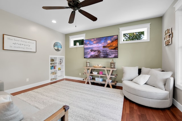 living area with dark wood-style flooring, recessed lighting, a ceiling fan, and baseboards