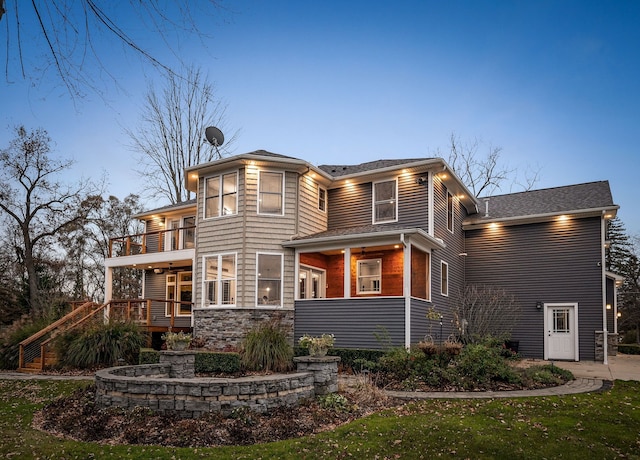 exterior space with stone siding and a balcony