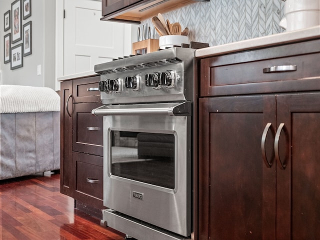 kitchen featuring light countertops, stainless steel range, and dark wood-style flooring