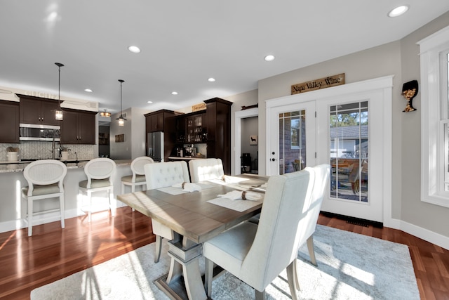 dining room featuring baseboards, dark wood-type flooring, and recessed lighting