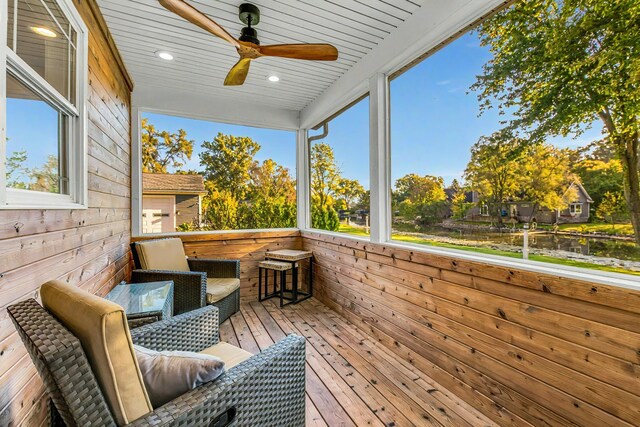 wooden terrace featuring a ceiling fan and an outdoor bar