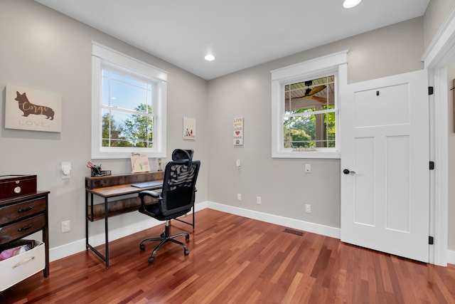 office with wood finished floors, visible vents, and baseboards