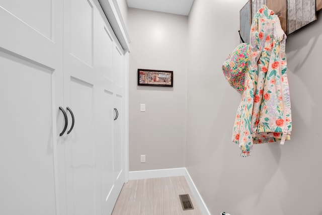 interior space with light wood-type flooring, baseboards, and visible vents