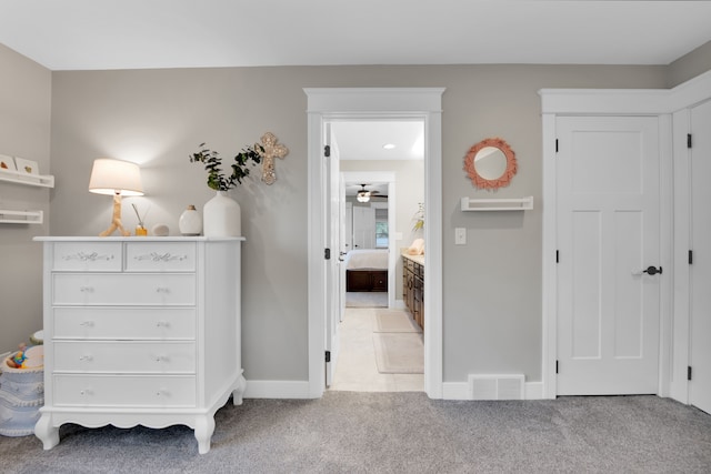 bedroom with light carpet, visible vents, and baseboards