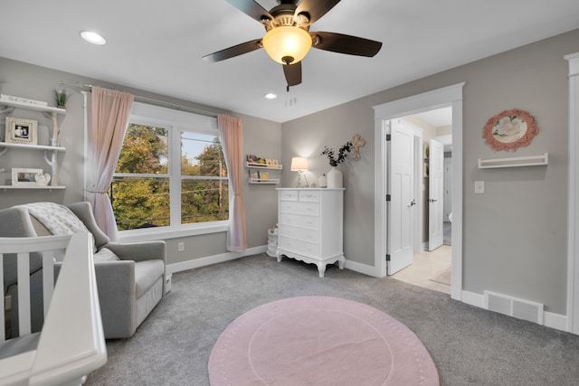 living area featuring baseboards, visible vents, a ceiling fan, light colored carpet, and recessed lighting