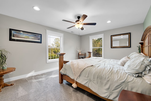 carpeted bedroom featuring multiple windows, baseboards, and recessed lighting