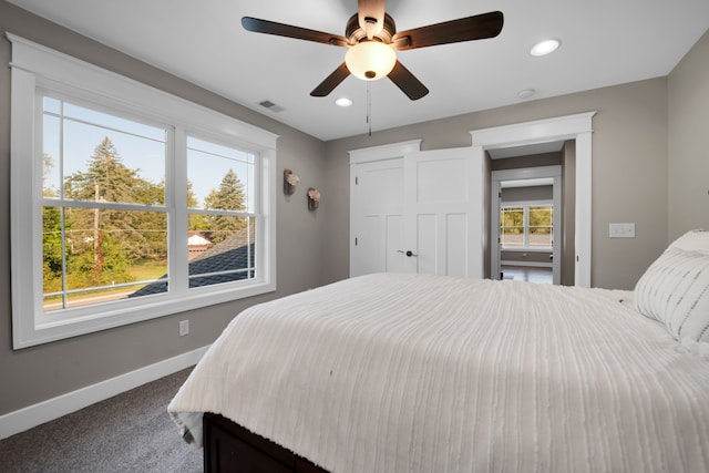 bedroom with carpet floors, recessed lighting, visible vents, and baseboards