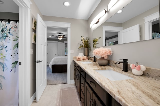 ensuite bathroom featuring double vanity, ensuite bath, a sink, and recessed lighting