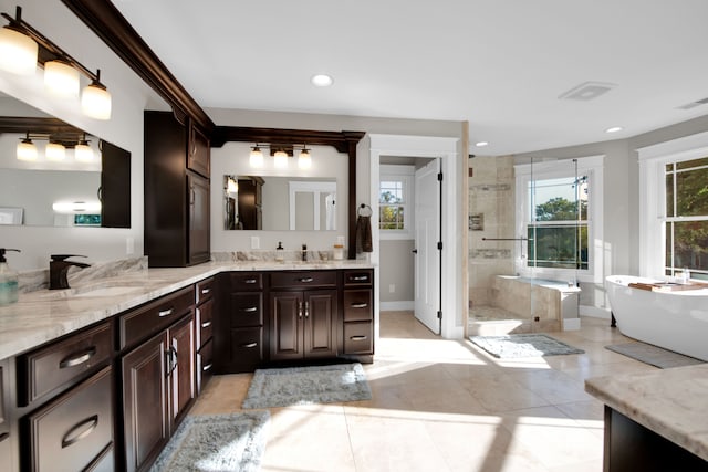 bathroom featuring recessed lighting, a stall shower, vanity, a freestanding tub, and tile patterned floors