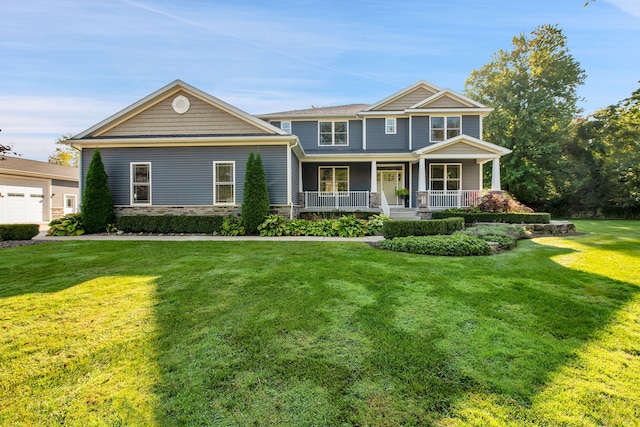 craftsman inspired home with stone siding, a porch, and a front yard