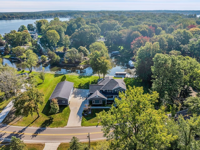 bird's eye view with a water view and a view of trees