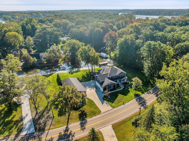 bird's eye view featuring a forest view and a water view