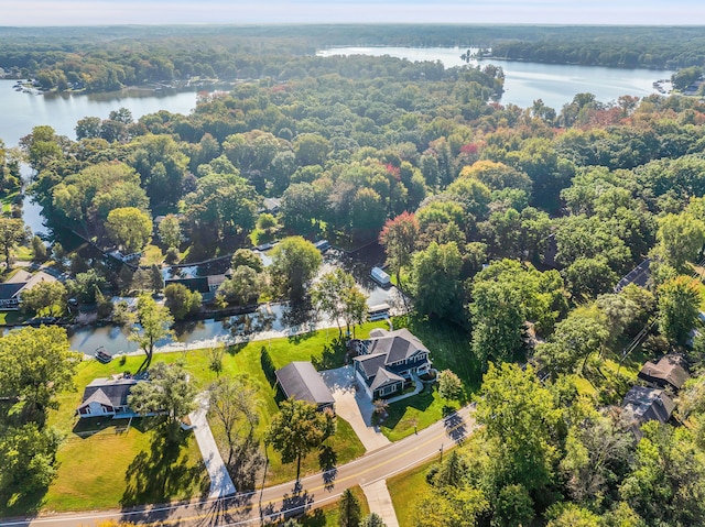 drone / aerial view featuring a water view and a forest view