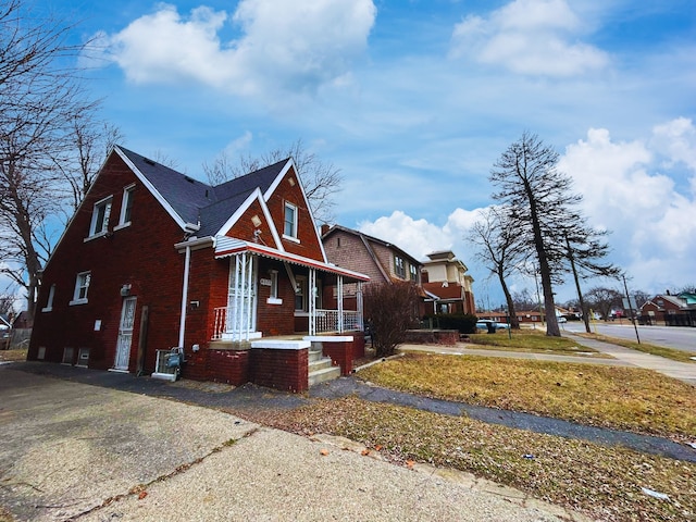 view of front of house with brick siding and a porch