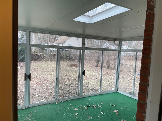 unfurnished sunroom with a skylight and a healthy amount of sunlight