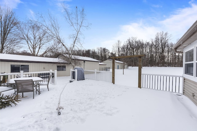 snowy yard featuring fence