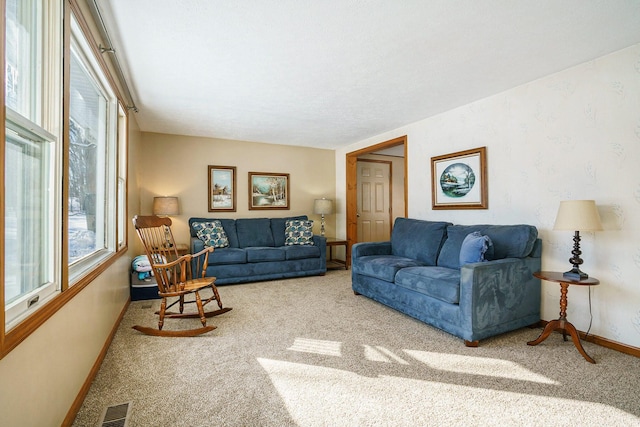 living room with carpet, visible vents, and baseboards