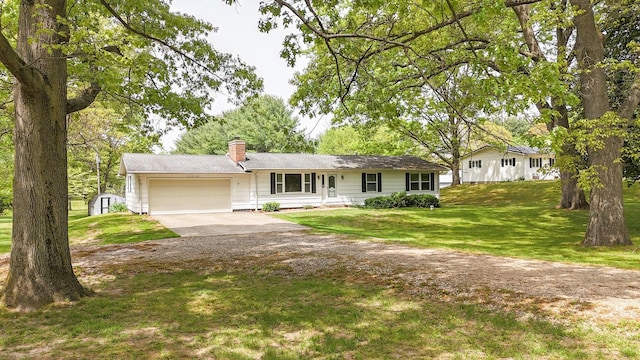 54348 Twin Lakes Rd, Dowagiac, MI 49047 - ranch-style house with concrete driveway, an attached garage, a chimney, a storage unit, and a front lawn