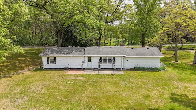 54348 Twin Lakes Rd, Dowagiac, MI 49047 - rear view of property featuring a patio, a yard, entry steps, and a chimney