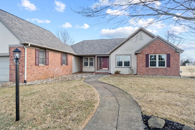 ranch-style house featuring a garage, a shingled roof, a front yard, and brick siding